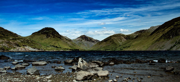 Scenic view of lake and mountains against sky