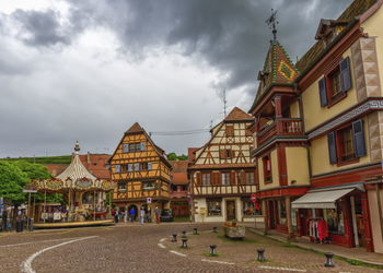 Buildings in town against sky