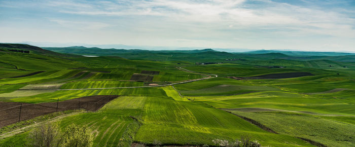 Scenic view of agricultural landscape against sky