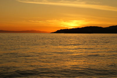 Scenic view of sea against romantic sky at sunset