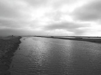 Scenic view of sea against cloudy sky