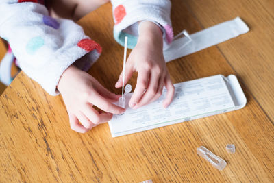 Child testing herself for coronavirus at home.