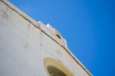 Low angle view of built structure against clear blue sky