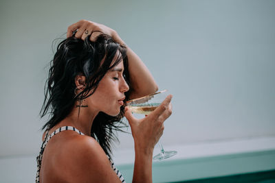 Portrait of beautiful woman drinking glass