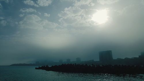 Scenic view of sea and buildings against sky