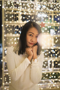 Portrait of young woman standing in store