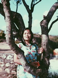 Woman smiling by tree