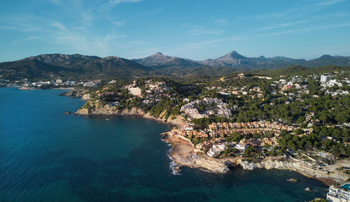 Aerial view of sea and mountains against sky