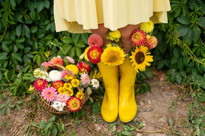 Floral arrangement with rubber boots worn on the feet