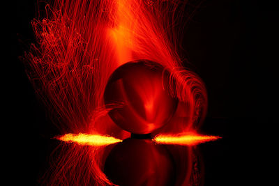 Red light painting against black background