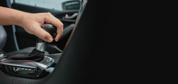 Midsection of person seen through car window