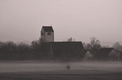 Building on field against sky