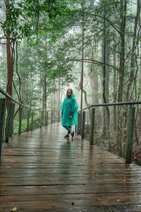 Full length of man standing in forest