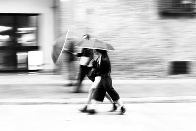 Blurred motion of man walking on road