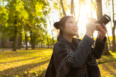 Young woman photographing outdoors