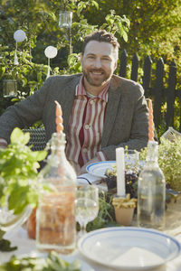 Smiling man at table in garden