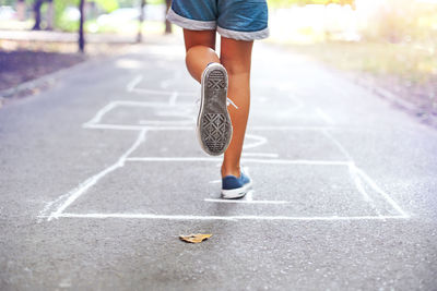 Low section of woman running on land