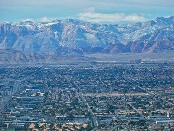 Aerial view of city against cloudy sky