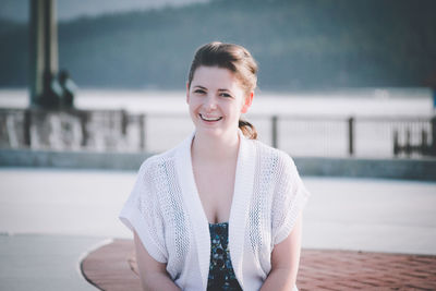 Portrait of smiling young woman in swimming pool