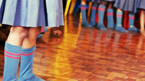 Low section of woman standing on tiled floor