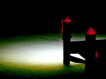 Illuminated lamp against sky at night