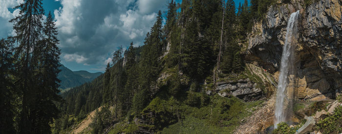 Panoramic view of trees and mountains against sky