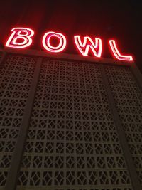 Low angle view of illuminated neon sign at night