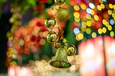 Select focus gold bell and ball. christmas ornament with bokeh light