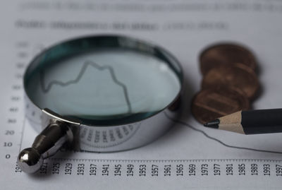 Close-up of magnifying glass on paper