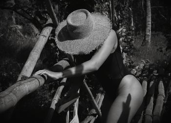 Woman sitting on log in forest