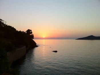 Scenic view of sea against clear sky during sunset