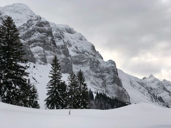 Scenic view of snow covered mountains against sky