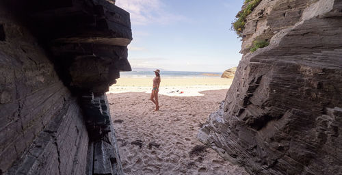 Woman on beach against sky