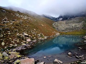Scenic view of lake and mountains against sky
