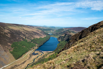 Scenic view of river amidst mountains against sky