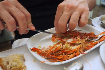 Close-up of man holding food in plate