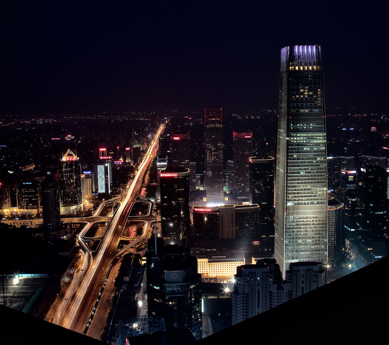 night, illuminated, city, architecture, building exterior, cityscape, skyscraper, travel destinations, built structure, transportation, city life, urban skyline, no people, bridge - man made structure, modern, outdoors, futuristic, sky, downtown district, business finance and industry