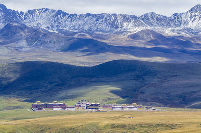 Scenic view of field and mountains against sky