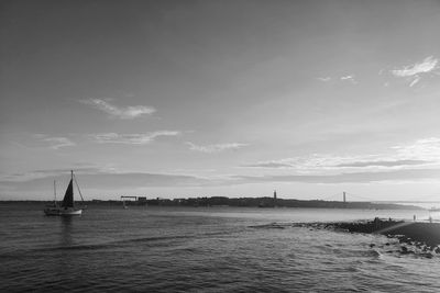 Sailboat sailing on sea against sky