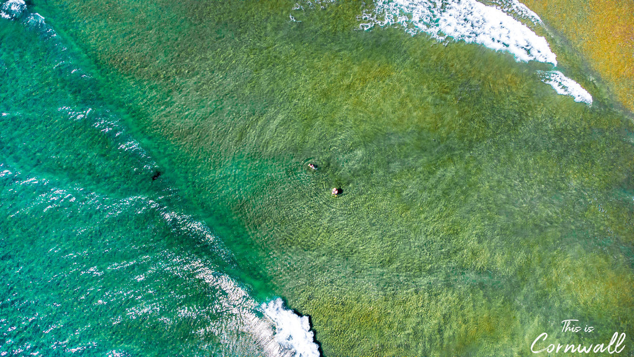 HIGH ANGLE VIEW OF PEOPLE ON THE SEA