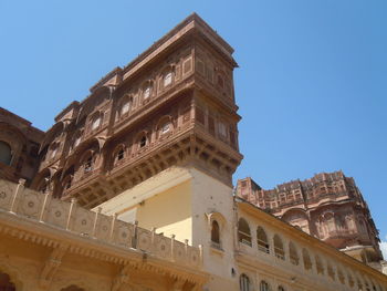 Low angle view of historic building against clear blue sky