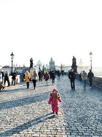 People on street in city against clear sky