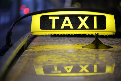 Close-up of yellow sign on car