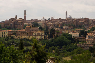 Buildings in town against sky