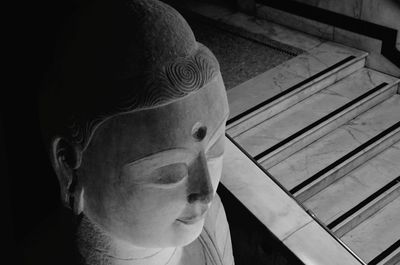 Close-up portrait of man with statue