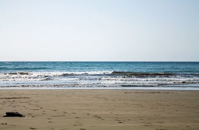 Scenic view of beach against clear sky