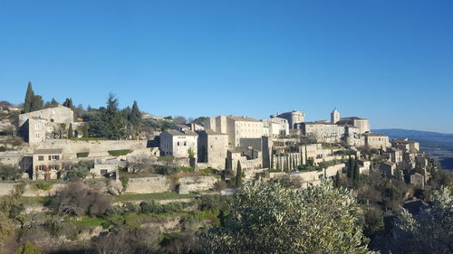 Buildings against clear blue sky