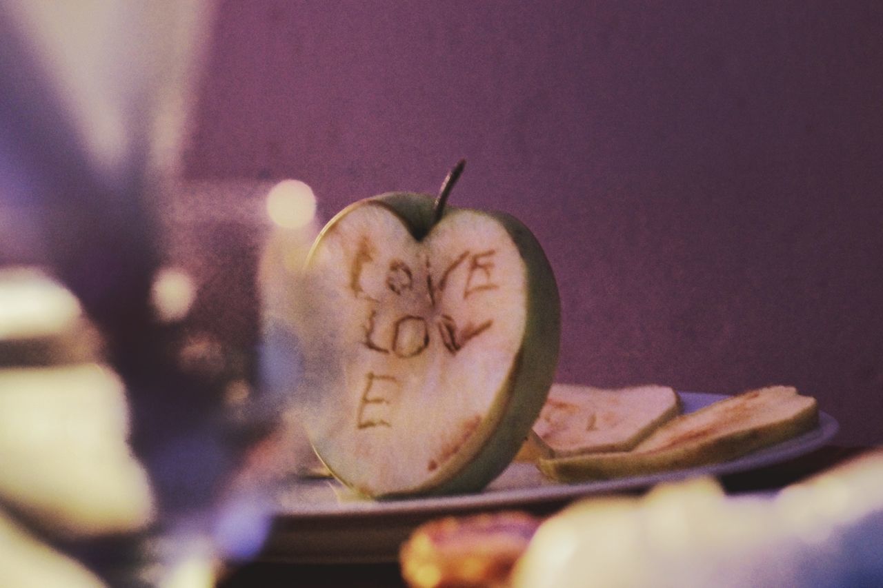 CLOSE-UP OF HEART SHAPE MADE ON APPLE