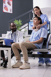 Low angle view of couple sitting on floor