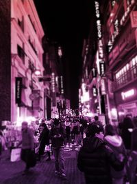 People walking on street at night